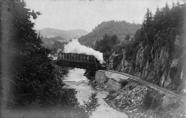 Central New England Railway train crosses the bridge at Satan's Kingdom
