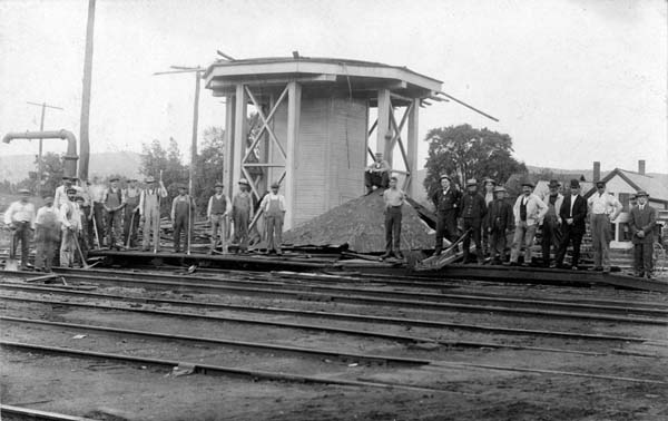 Railroad crew works at cleaning up the storm damaged water tower